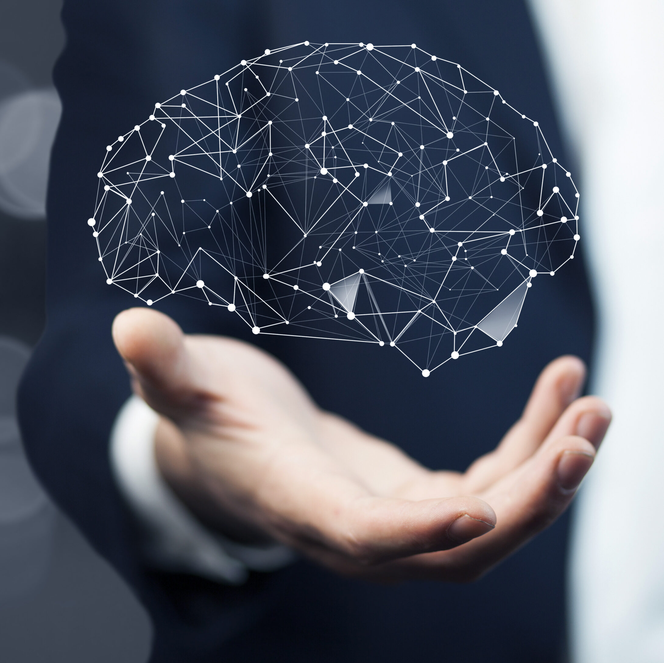 Brain held in a man's hand, symbolizing the mind’s tendency to create stories and narratives from data